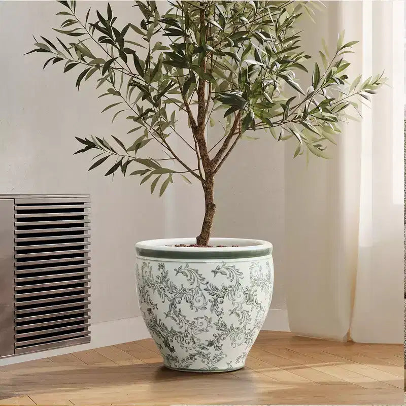 Pot de fleurs en céramique vert à motifs, rond, adapté à une utilisation intérieure et extérieure.