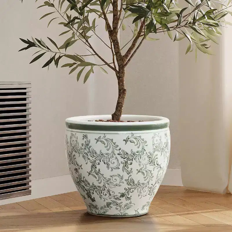 Pot de fleurs en céramique vert à motifs, rond, adapté à une utilisation intérieure et extérieure.